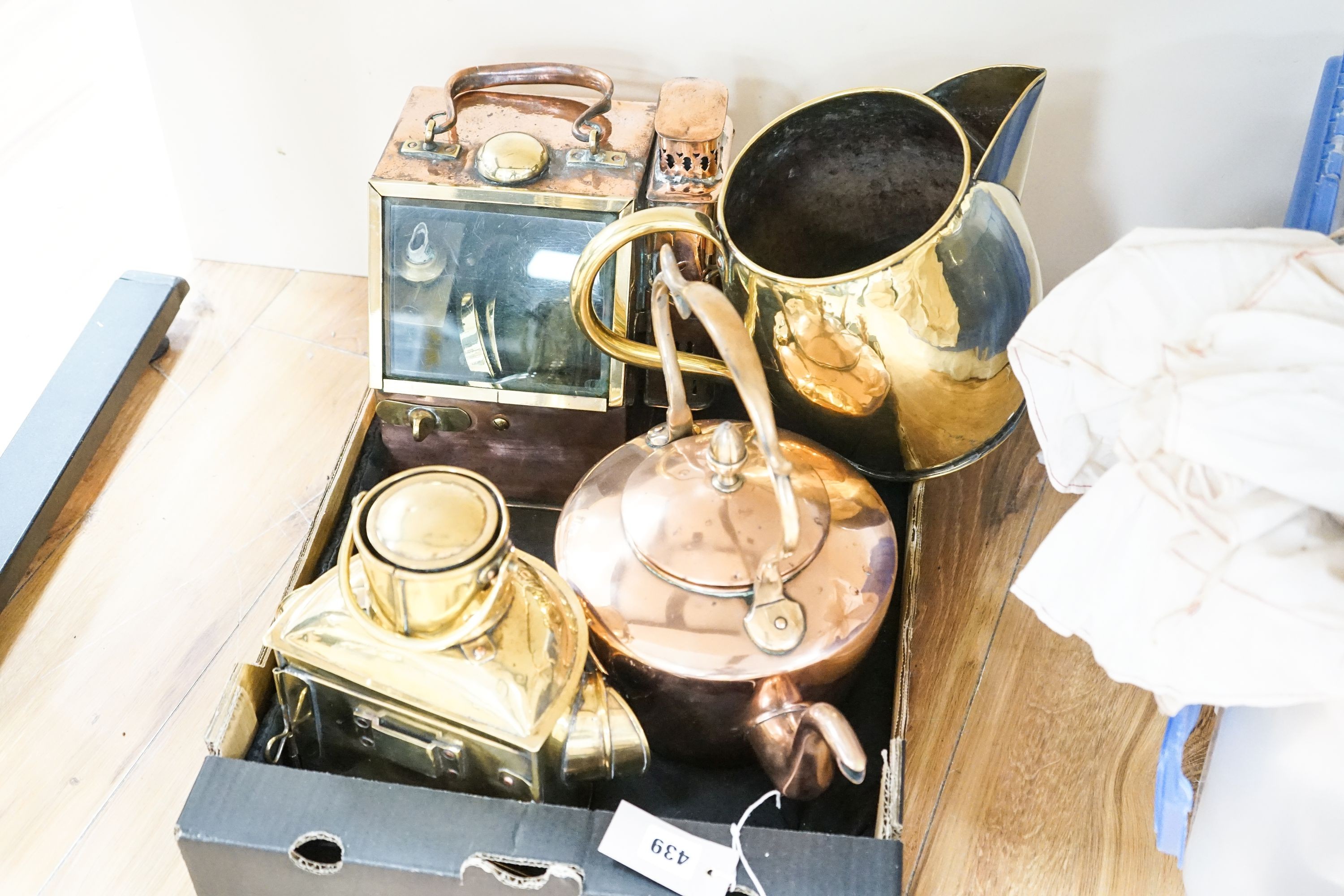 A copper ship's binnacle compass, a brass oil lamp, a brass jug and a copper kettle
